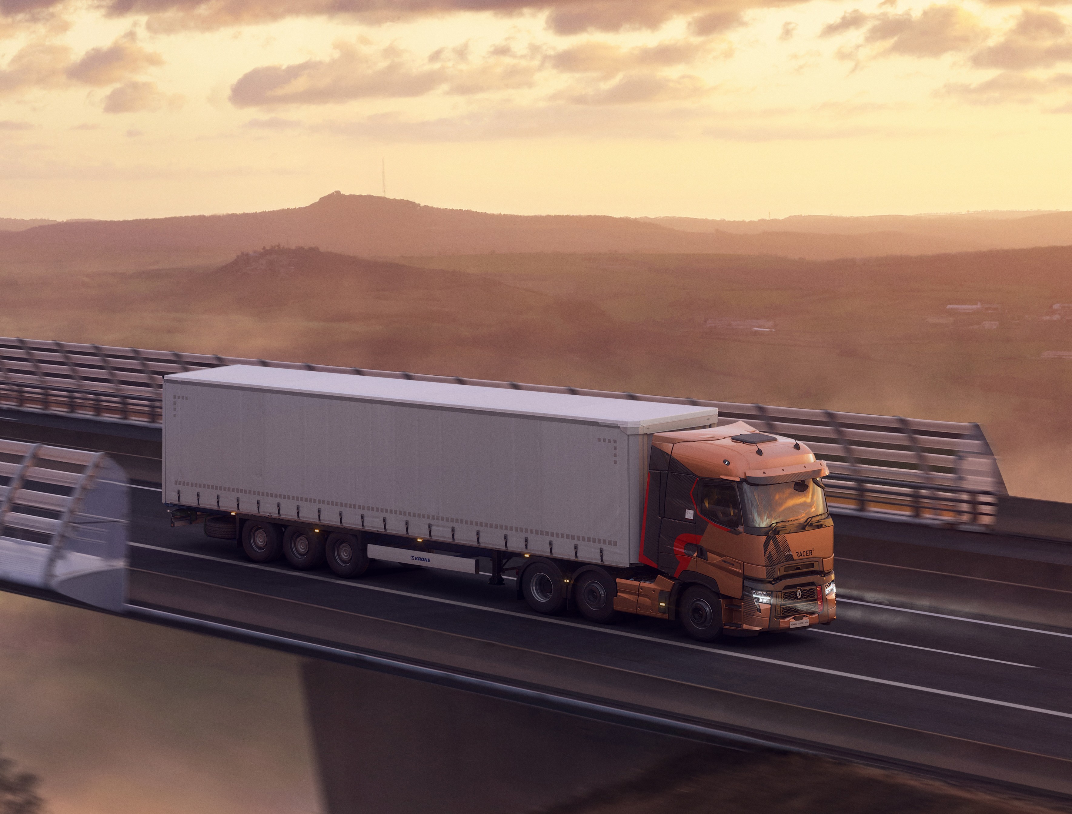 A right-hand-drive Renault Trucks T High pulls a semi-trailer across the Millau Viaduct at sunset, overlooking a spectacular sea of clouds.